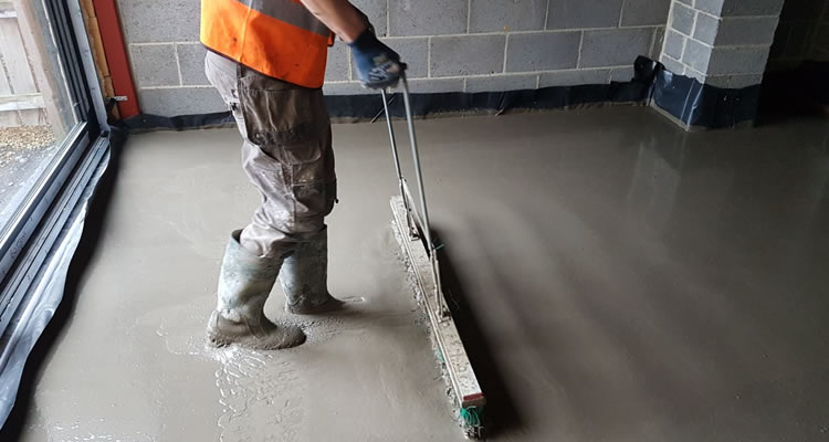 person levelling a screed floor