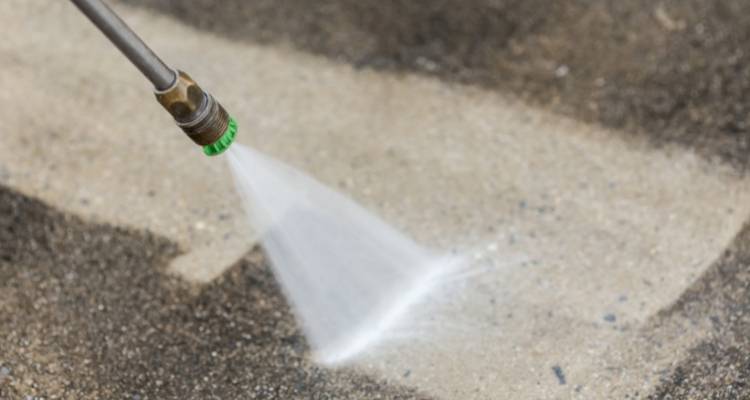 Pressure washer cleaning a driveway