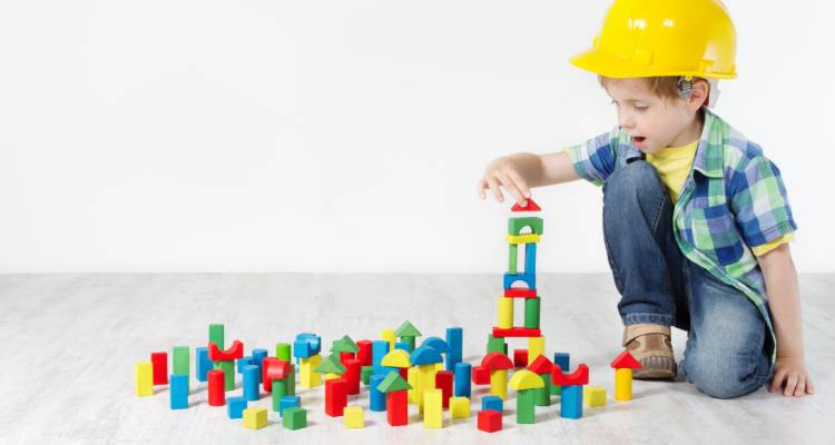 child playing with hardhat on