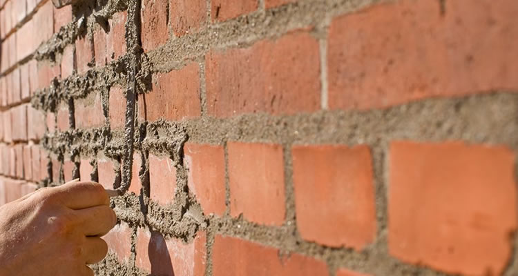 person repointing a wall