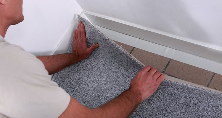 person fitting carpet