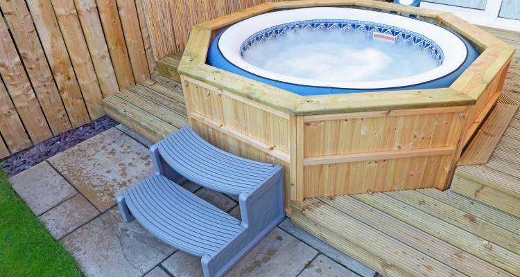Hot tub on decking area in garden