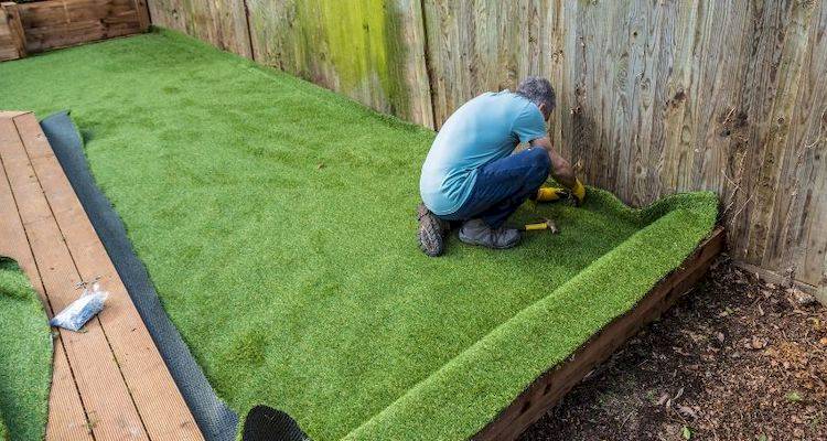Tradesperson installing artificial grass