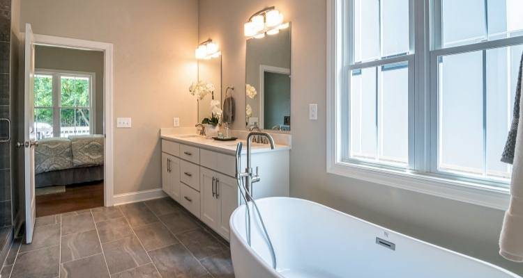 Bathroom with lights above the sink and cupboards under sink