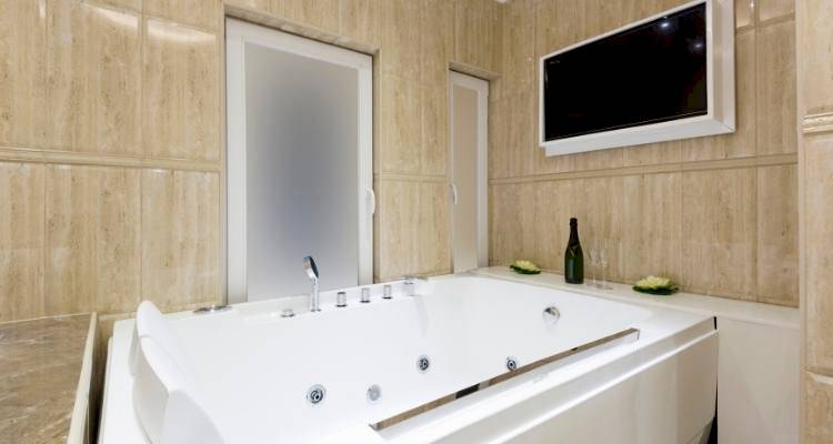 Bath with a TV built in to wall