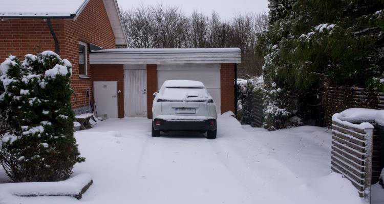 car on drive covered in snow