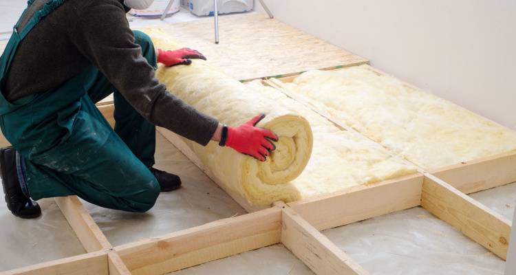 person installing floor insulation