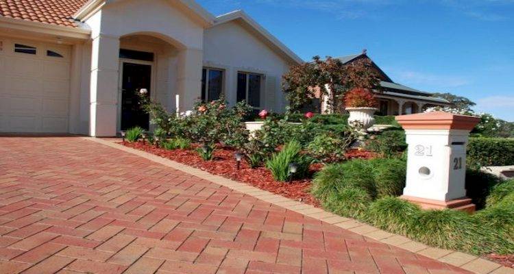Modern home with red block paving driveway