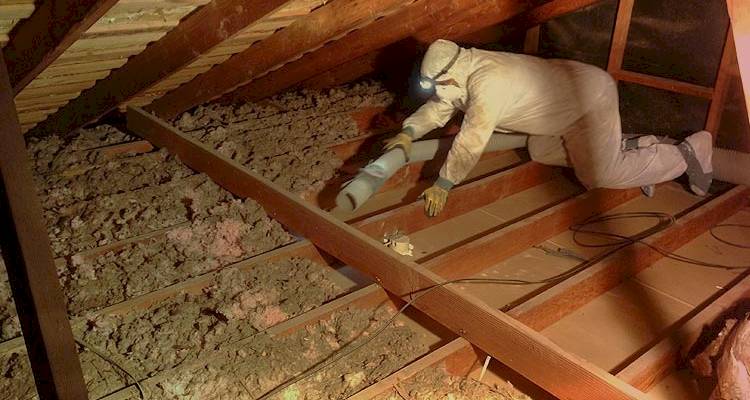 loft boarding cost guide — loft insulation being removed by a specialist