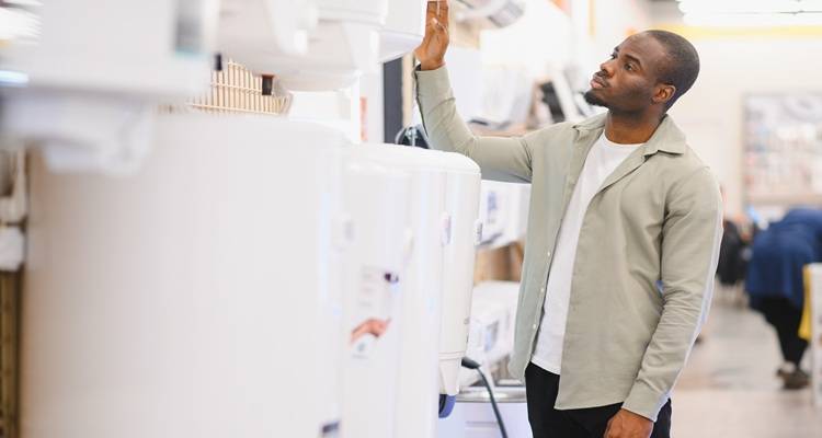 man looking at boilers