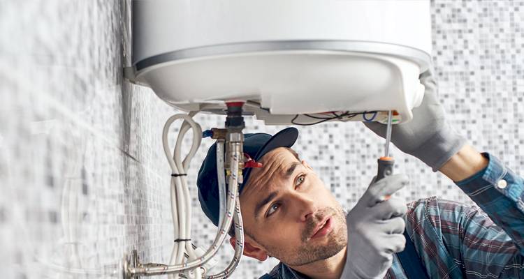 Heating engineer installing a boiler