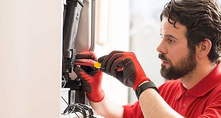 Tradesman checking a boiler