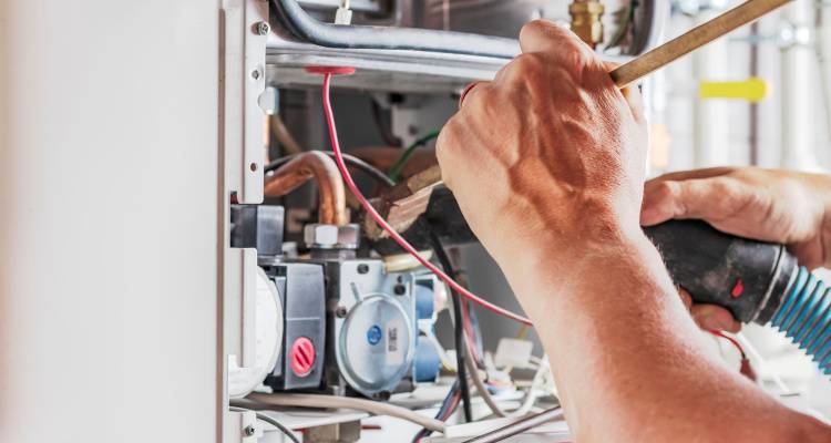 person fixing boiler