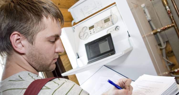 heating engineer inspecting boiler