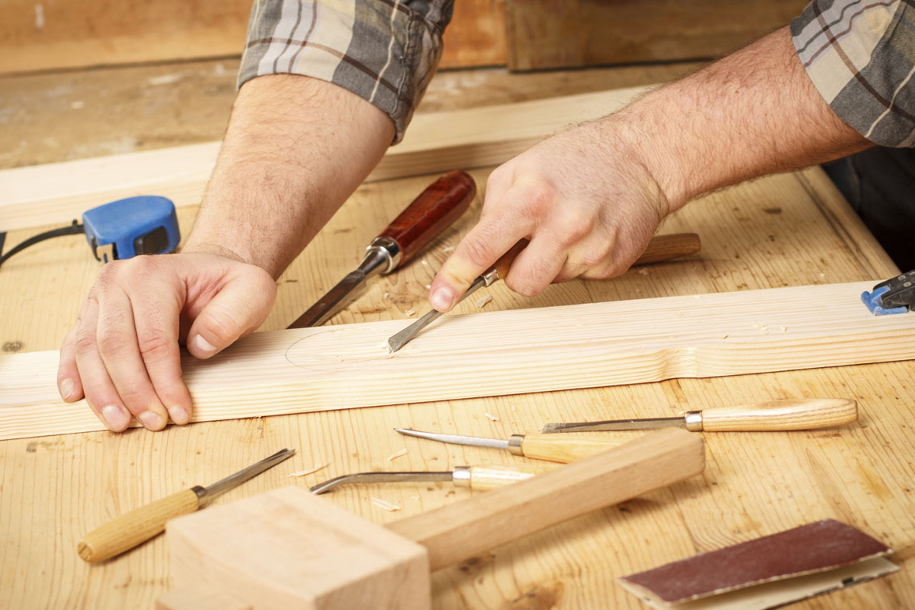 person shaving wood