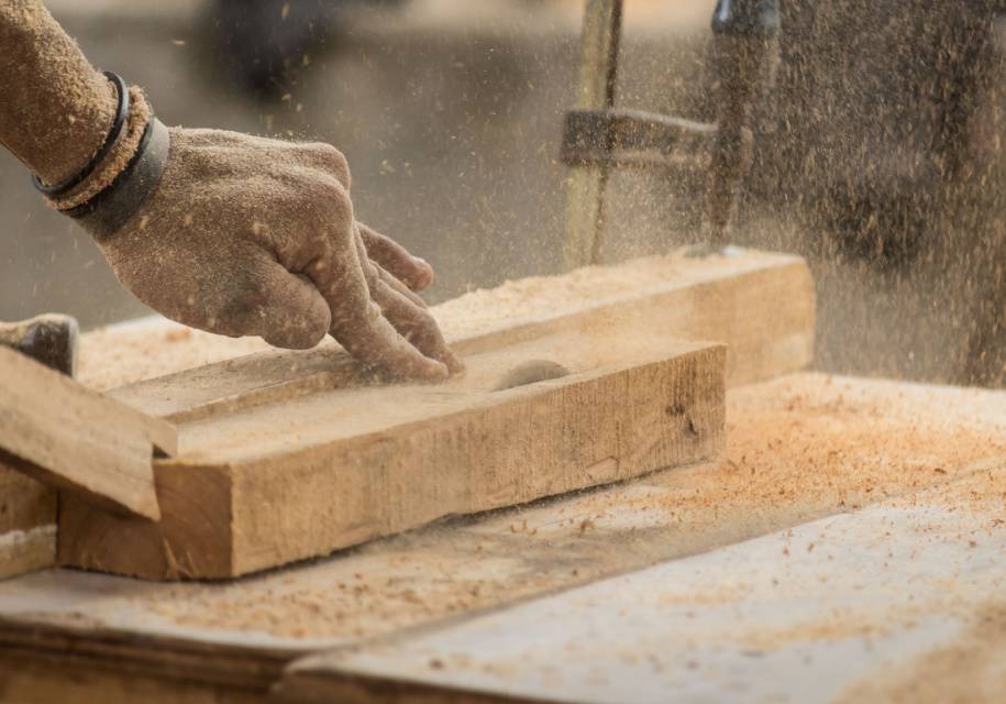 person shaping wood