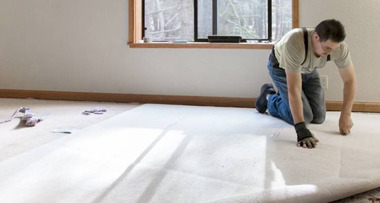 Tradesperson fitting carpet