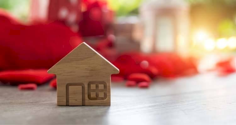 wooden house ornament with red background