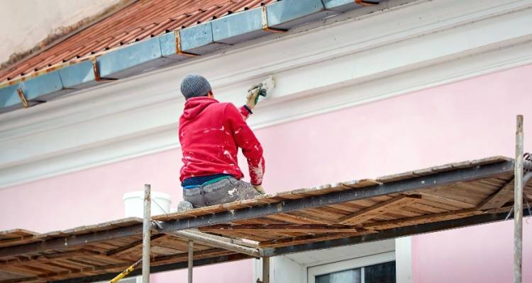 man painting house