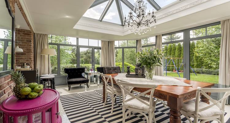 interior view of a large conservatory that's being used as a dining room