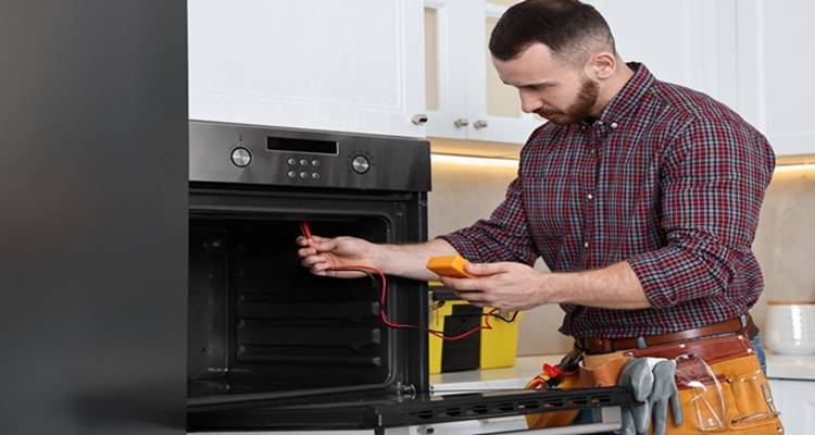 man testing oven element