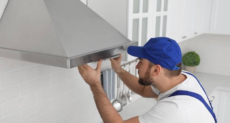 Man installing cooker hood