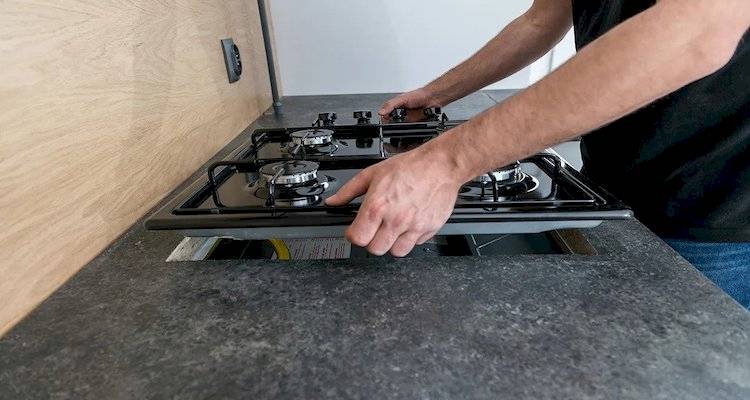 man installing hob