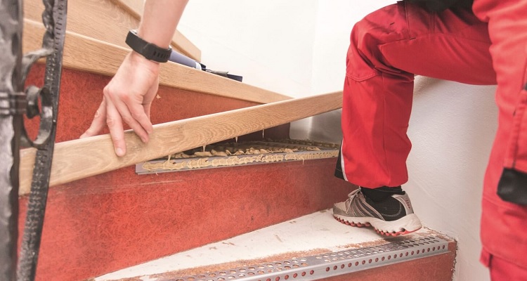 Carpenter fitting wooden staircase