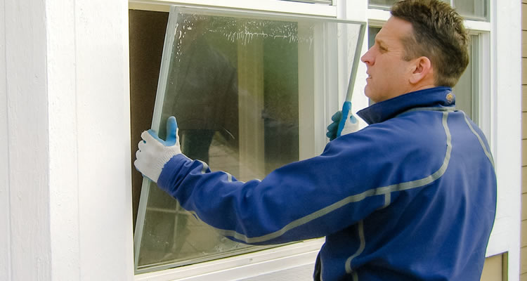 person replacing a window