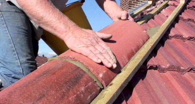 roofer working on ridge tile replacement