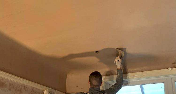 Plastering a ceiling