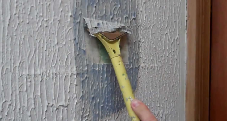 textured coating being removed from a ceiling