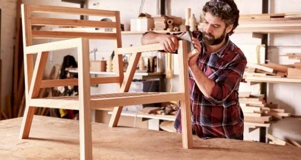 Man sanding down a chair