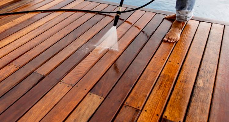 Person washing a timber deck