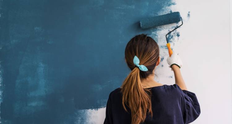 woman painting wall