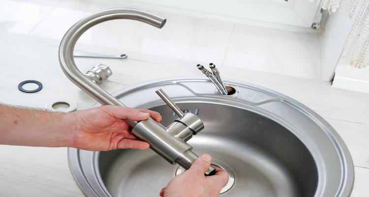 a new kitchen sink being installed by a person