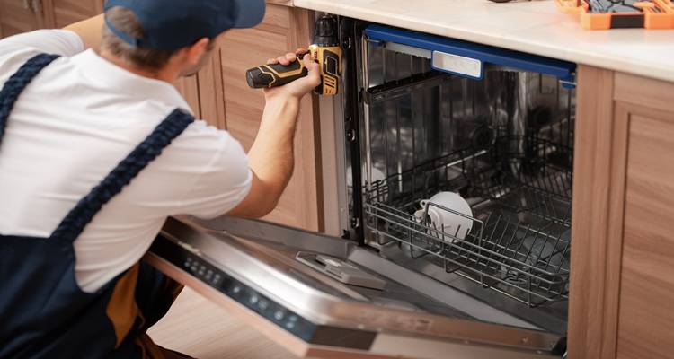 man fixing dishwasher