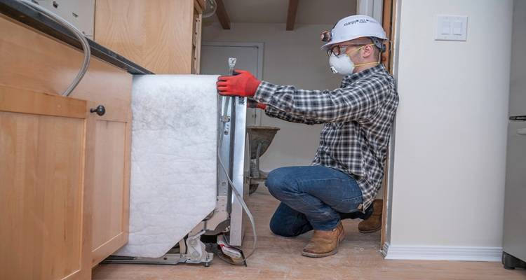 man pulling dishwasher out