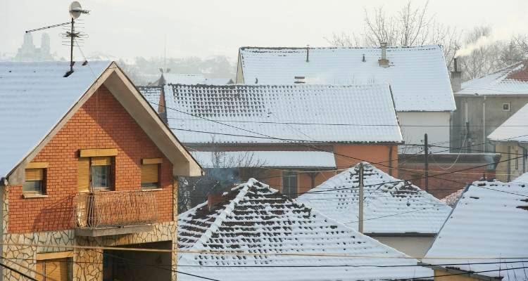 multiple houses roof with snow on