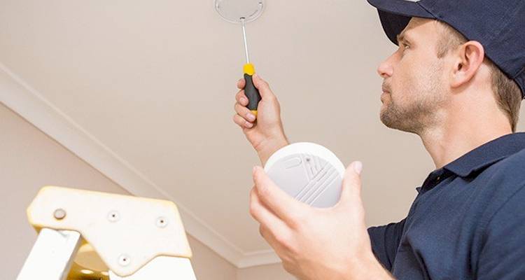 Man installing a fire alarm