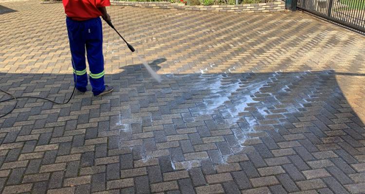 man jet washing drive