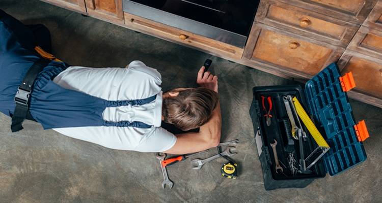 man lying down oven repair