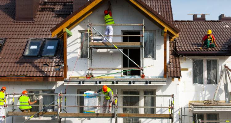 people painting house exterior