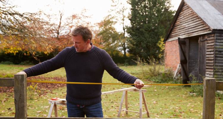 man fixing fence