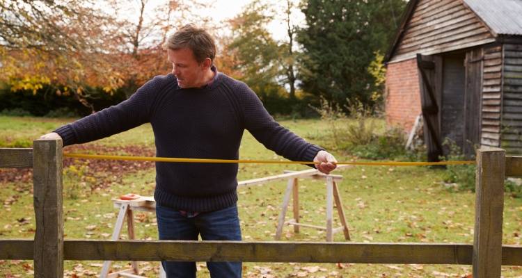 man repairing fence