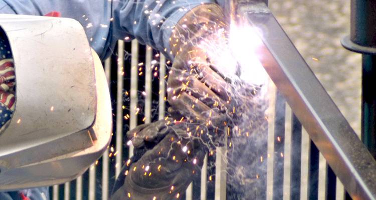 Man fixing metal fence