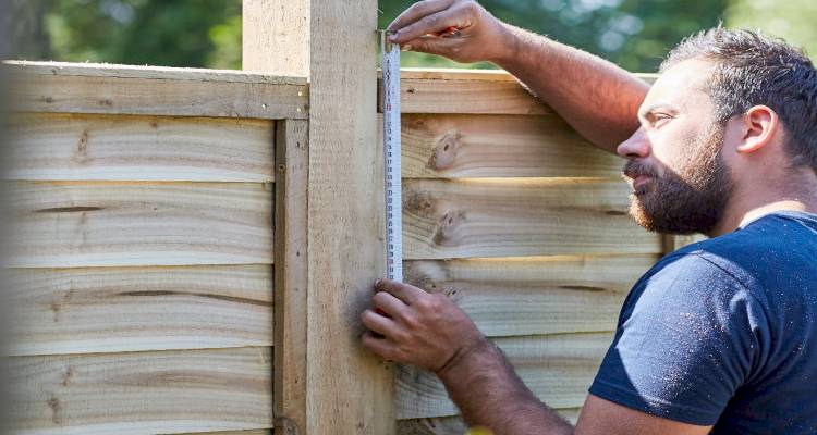 Tradesman measuring fence