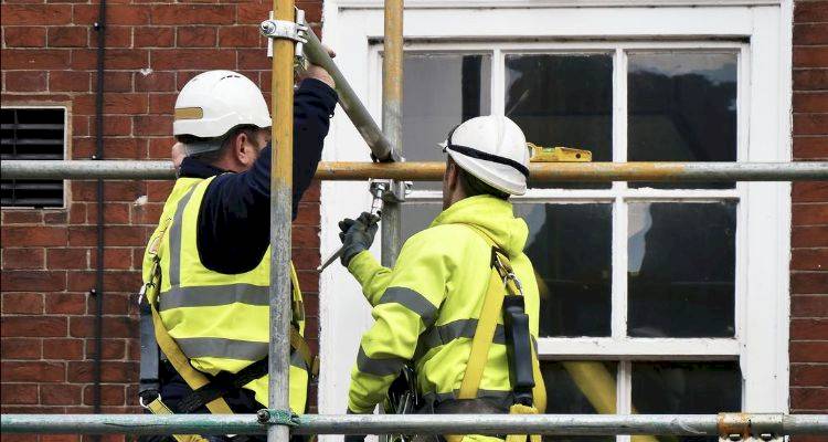 people erecting scaffolding