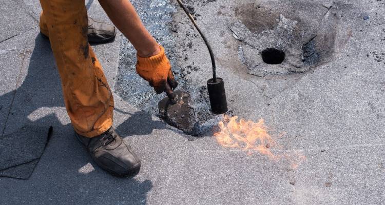 person fixing flat roof