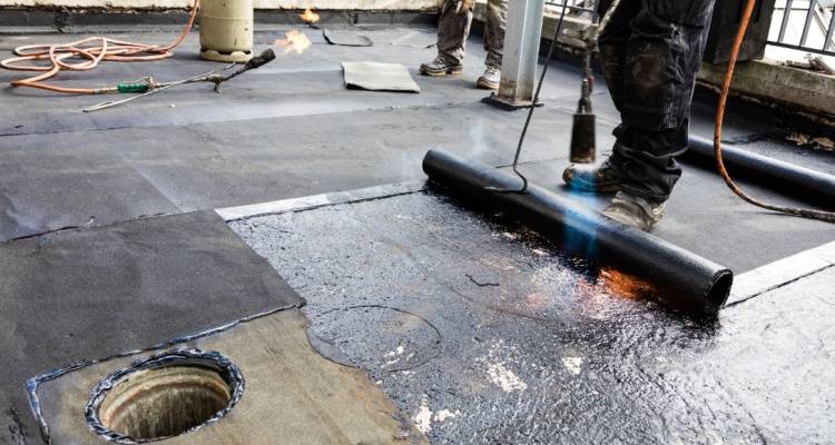 person repairing flat roof